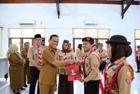 Wali Kota Kotamobagu, Weny Gaib, menyerahkan penghargaan kepada perwakilan Pramuka sebagai bentuk apresiasi atas prestasi dan partisipasi dalam Jambore Nasional (Jamnas) XII Tahun 2026.
